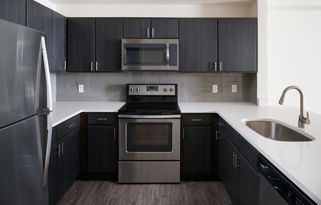 Espresso Cabinetry and White Countertops at The Manhattan Tower and Lofts, 1801 Bassett Street, Denver