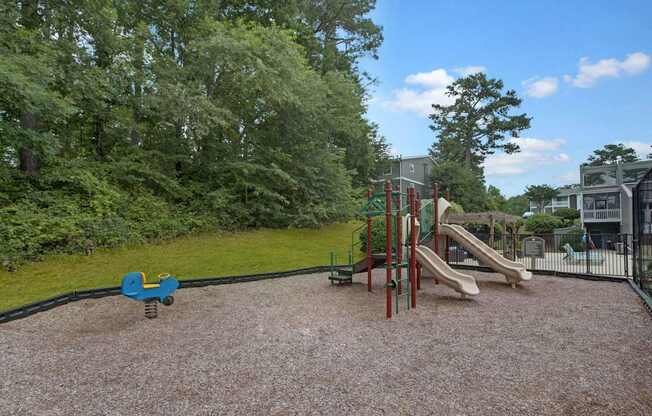 A playground with a slide and a seesaw.
