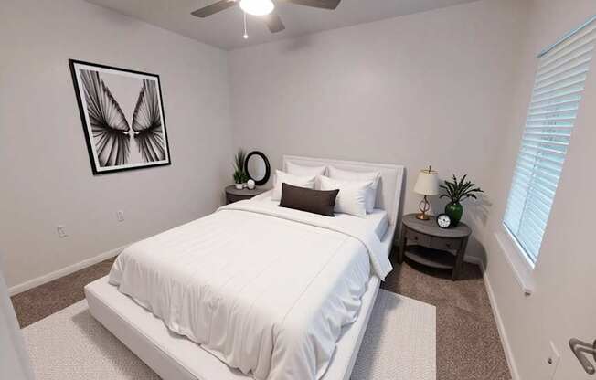 A bedroom with a white bed and a picture of a butterfly on the wall.