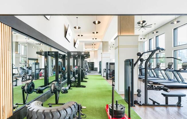 Expansive two-story fitness studio with cardio, strength, and functional training zones.