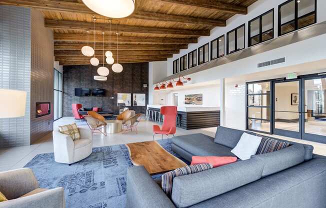 a living room with couches and chairs and a fireplace at Ashford Belmar Apartments, Lakewood, Colorado