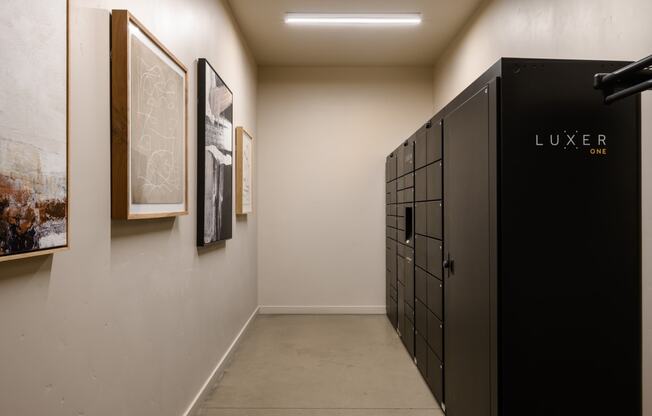 a row of lockers in a room with paintings on the wall at The Lucy Boise Apartments, Idaho, 83702