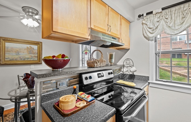 the kitchen has granite counter tops and stainless steel appliances and a window