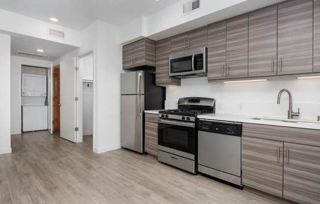 a kitchen with stainless steel appliances and a refrigerator