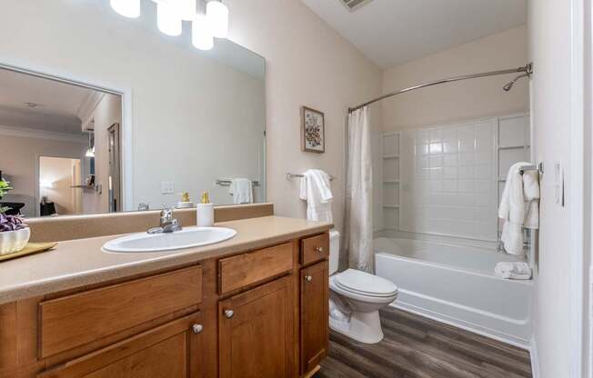 A bathroom with a white sink and a white toilet.