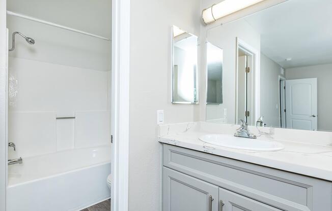 a room with a sink and a mirror