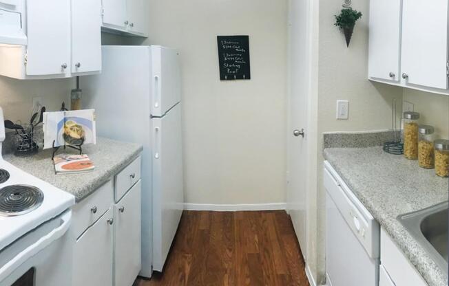 a white stove top oven sitting inside of a kitchen