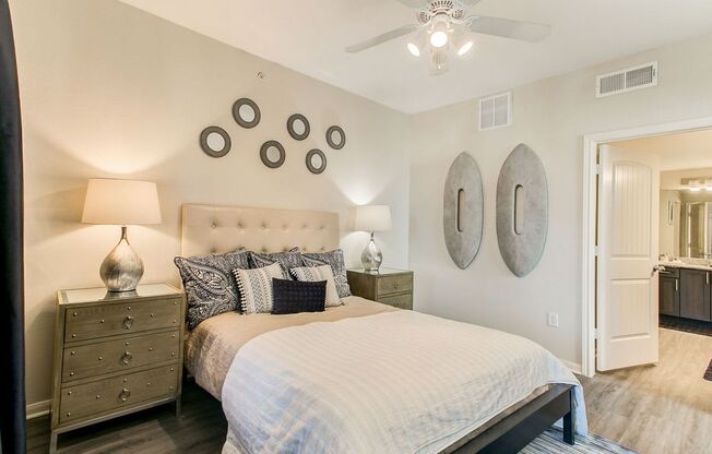 staged bedroom with hardwood-style flooring and ceiling fan