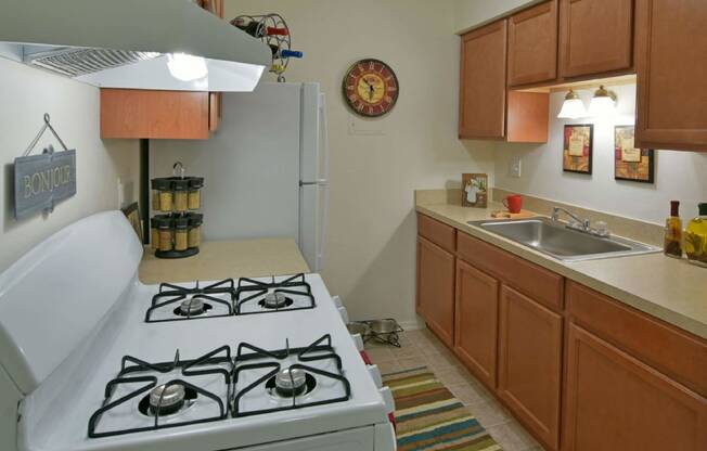 a kitchen with a stove top oven next to a sink