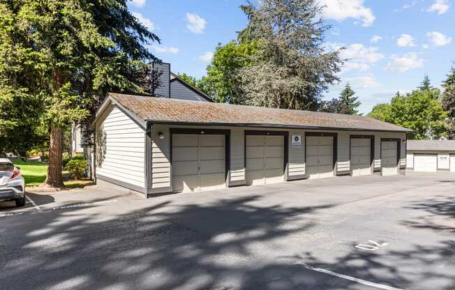 a garage with four doors on the side of a street