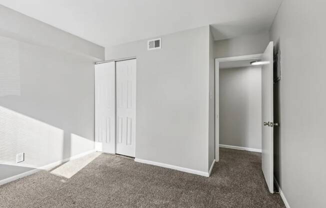A room with a carpeted floor and white walls.