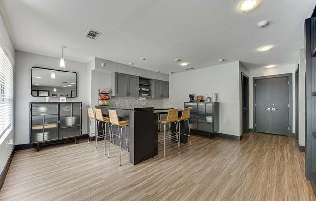 A modern kitchen with wooden floors and a central island.