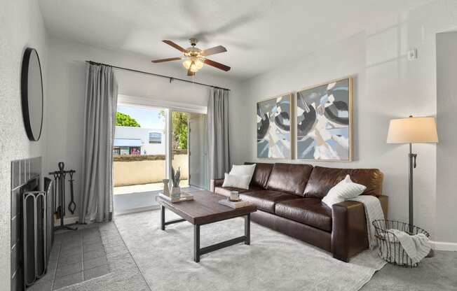 a living room with a couch and a ceiling fan at Vaseo Apartments, Phoenix