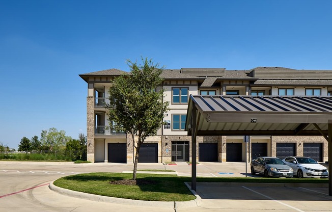 A modern building with a parking lot in front.