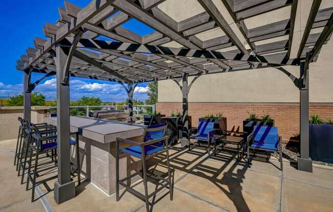 a patio with tables and chairs and a pergola