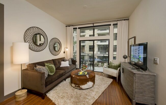 a living room filled with furniture and a large window
