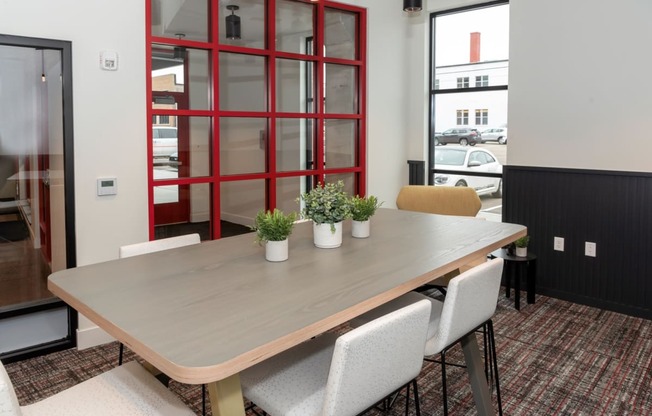 a dining room with a wooden table and white chairs