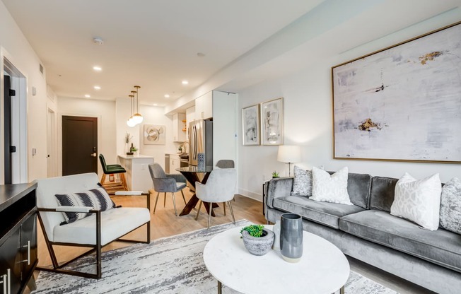 a living room with a gray couch and a white table at Rialto, Washington 