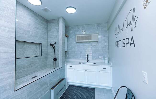 A white bathroom with a sign that says Pet Spa.
