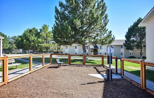 Inside gated dog park, sitting bench and large play area in Pocatello, ID