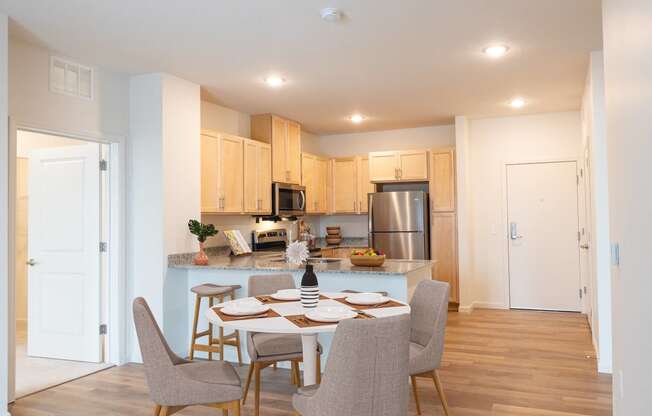 an open kitchen and dining room with a table and chairs