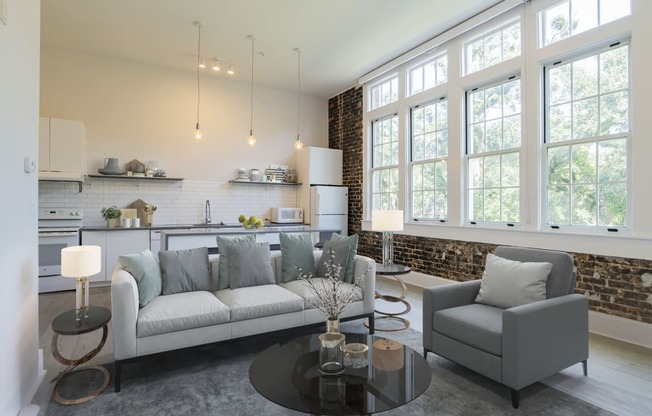 a living room with a couch and chairs and a table