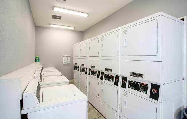 A row of washing machines in a laundromat.