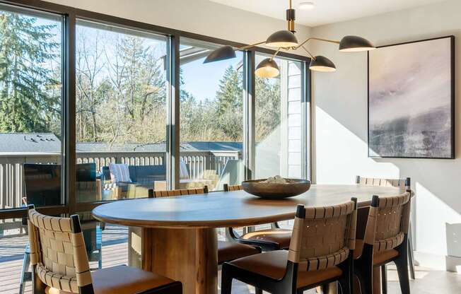 A modern dining room with a round table and chairs.