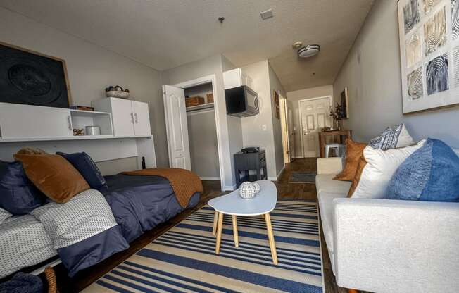 a living room with a couch and a chair and a tv