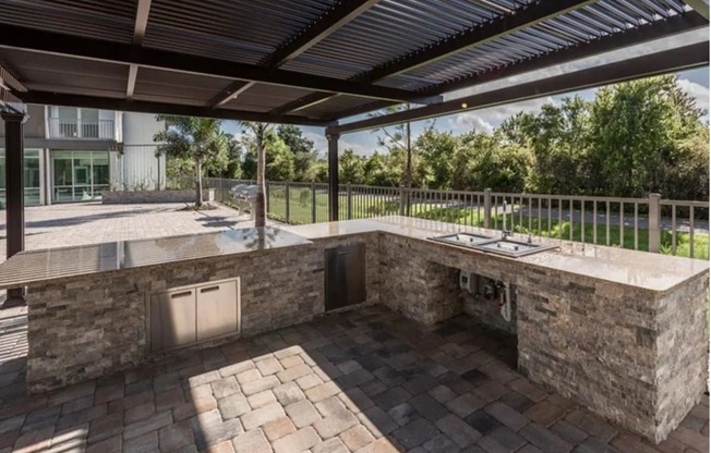 a patio with a kitchen and a pool