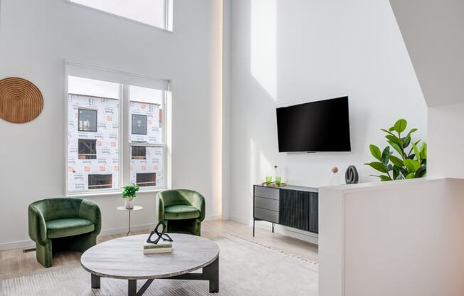 a living room with a table and chairs and a television