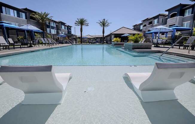 Large pool with shallow water sundeck and floating chairs