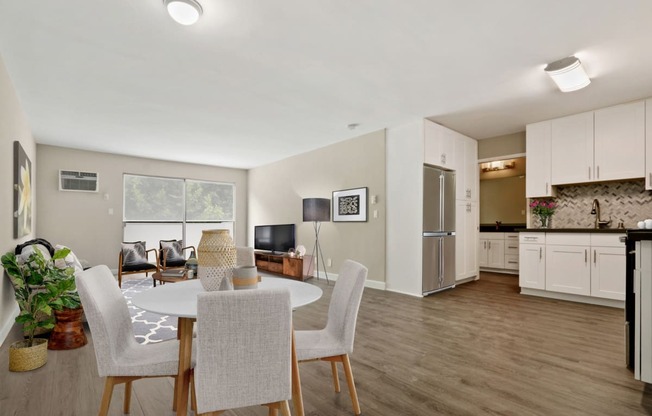 Dining Area With wood-style floors throughout and a kitchen to the right