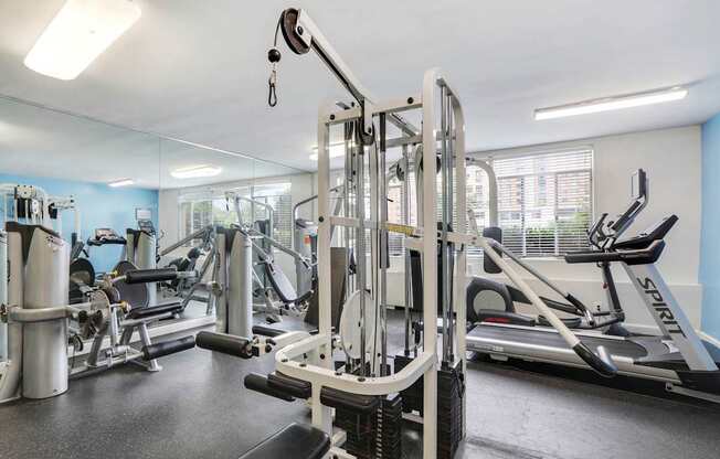 A gym with a variety of equipment including a leg press machine.