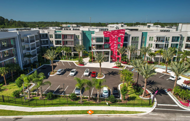 an aerial view of an apartment complex with parking lot and palm trees at Pinnacle Apartments, Florida, 32256