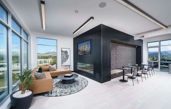 a living room with a fireplace and a table and chairs at NoMa Apartments, Walnut Creek