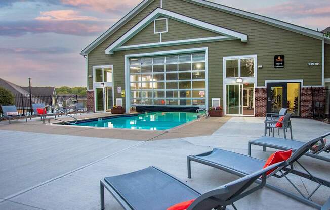 A poolside lounge area with sunbeds and a building in the background.