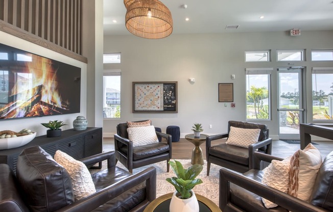 a living room with couches and chairs and a fireplace