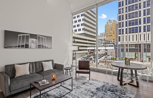 a living room with a large window and a view of a city