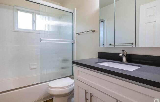 an empty bathroom with a toilet sink and shower