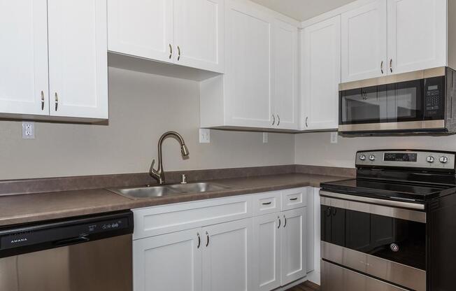 a stove top oven sitting inside of a kitchen