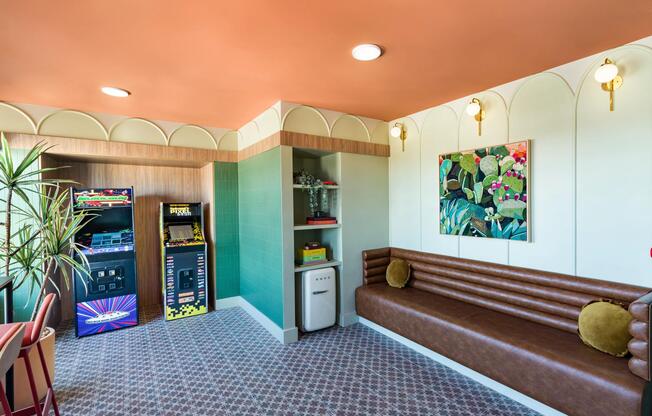 A retro-inspired arcade lounge at Modera St. Paul, featuring classic games, cozy seating, and playful design details in the heart of Dallas.