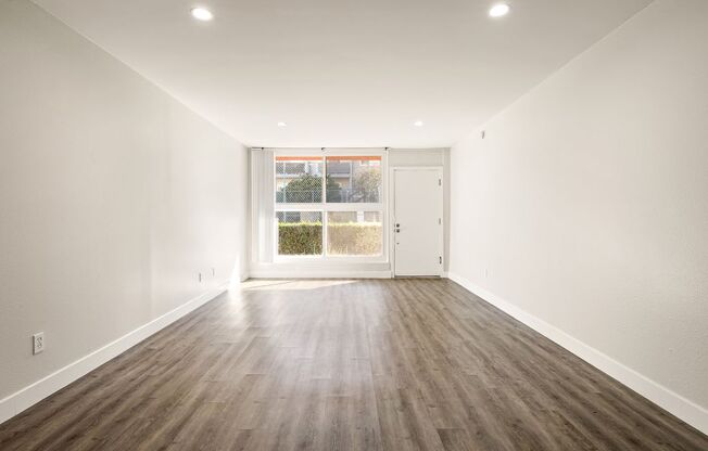 A room with wooden floors and white walls.
