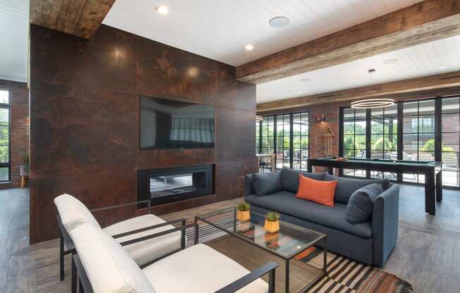 a living room with a gray couch and a fireplace