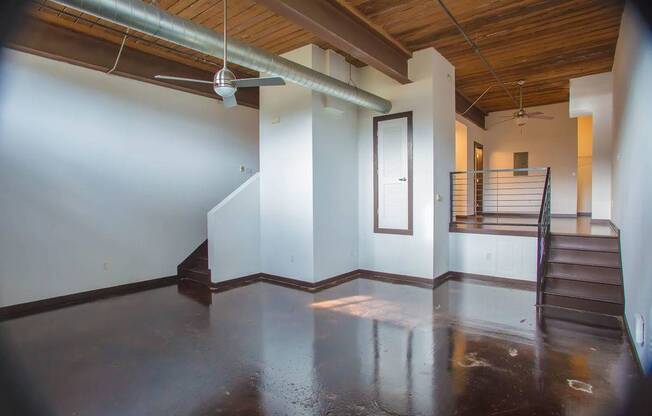 A room with a wooden ceiling and a metal pipe running across it.