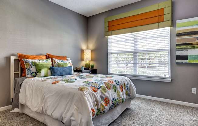Upgraded guest bedroom with gray wall paint and carpet and large window