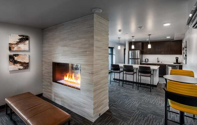 resident lounge with gas fireplace and kitchen