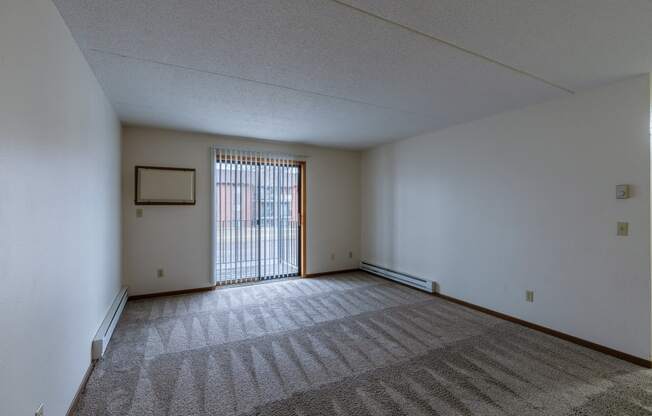 a living room with a glass sliding door at France, Fargo