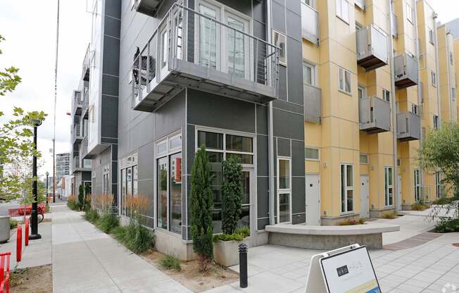 A modern apartment building with a sign in front.