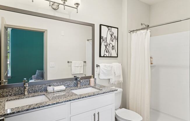 a white bathroom with two sinks and a mirror